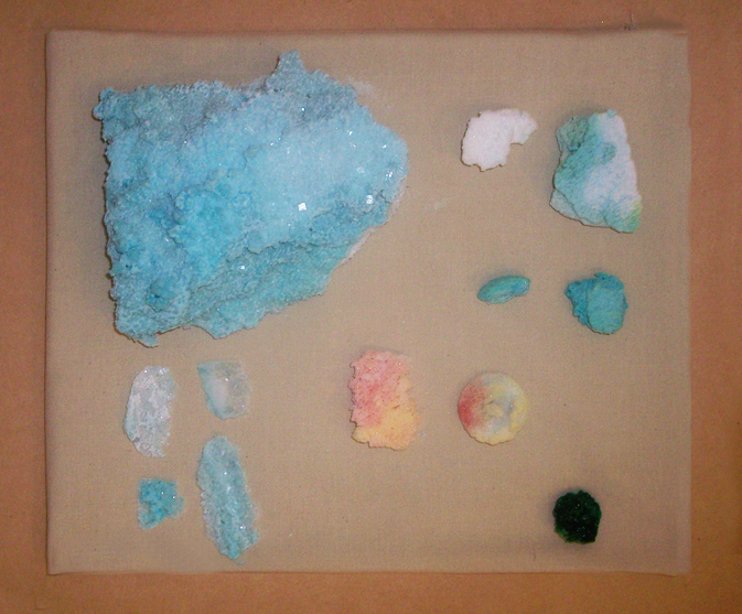 collection of salt rocks and crystals, approx 15x15 in sq, on pedestal